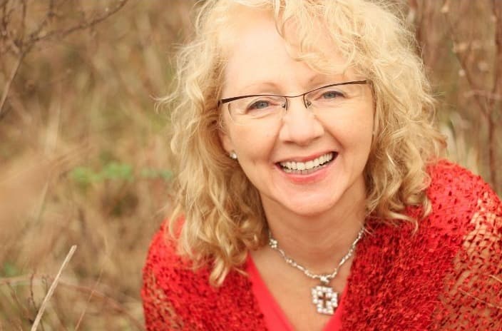 Eveline Nachtegaele smiling in a red blouse