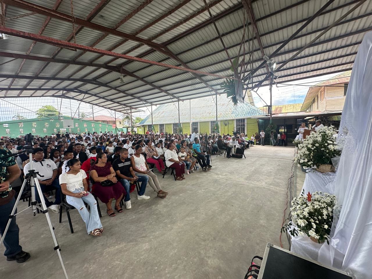 Parish families gathered for Mass in the covered Panama church space